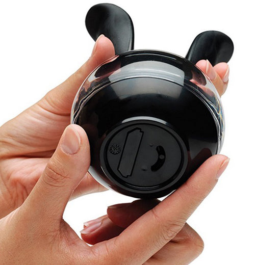 Two hands hold a Pepperball pepper grinder with clean sides, reinforced handles, and improved functionality showing the bottom.