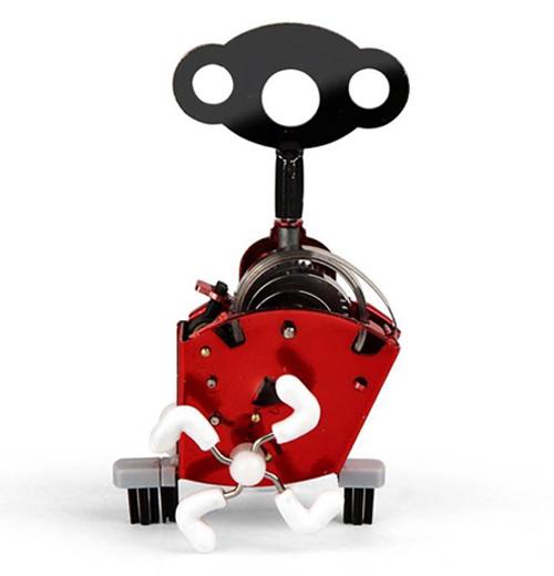 A red colored Wind Up "Ping Ling" with a black key on top.