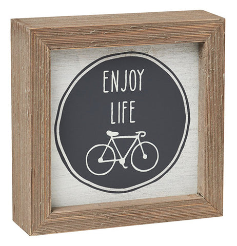 The box sign has "Injoy Life" in black and white and a bike and a wooden boarder.