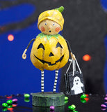The "Punkin Pie" figurine stands in front of a spooky tree with orange lights. 