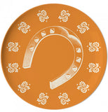 Coaster with a horseshoe in the middle with a orange background.