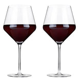 Two wine glasses with what appears to be wine in them.