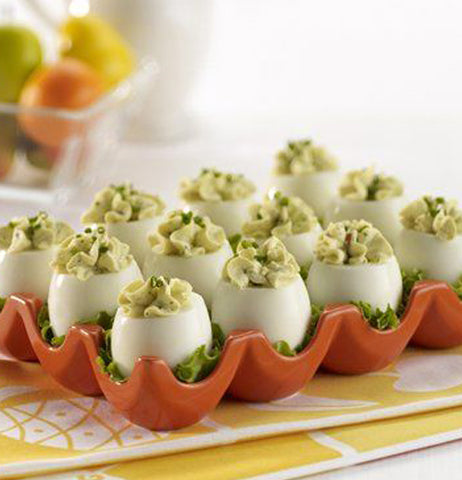 Deviled eggs are shown in the red egg tray.