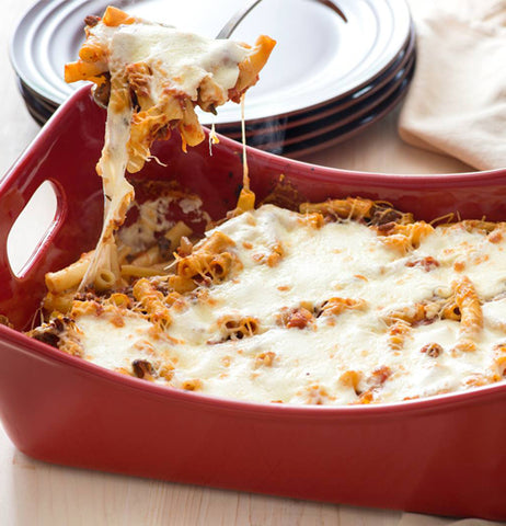 Lasagna is shown being served from the pan.