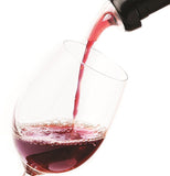 Some red wine is shown being poured from the spout into a glass.