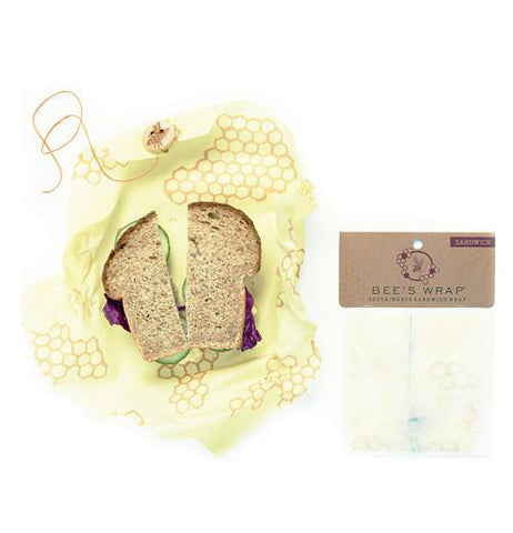 Reusable Wrap-Sandwich Bee's Wrap with a sandwich and inside its packaging over a white background.