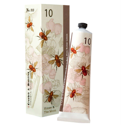Shea butter lotion. The container and packaging is white with bees. 