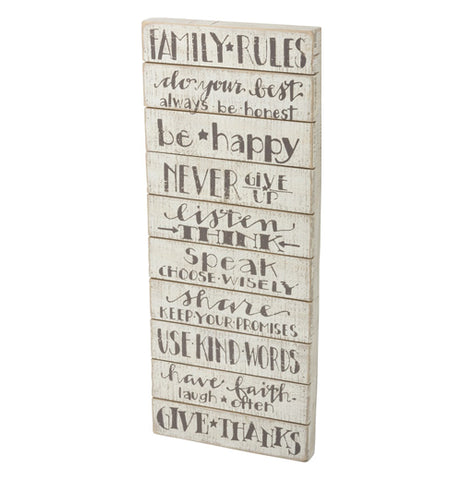 An off-white wooden sign featuring family rules written in gray lettering. Such as: always be honest, be happy, never give up, and give thanks
