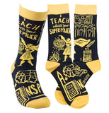 A pair of yellow and black socks and a single sock say, "I teach what's your superpower Inspire" in yellow lettering.