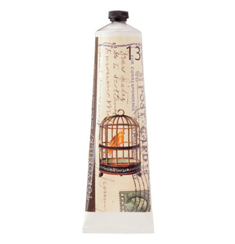 Shea butter lotion with a bird in a bird cage illustrated on it.