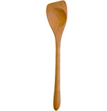 A brown, wooden stirring spoon with a smooth concave indentation in the head stands straight up and down.