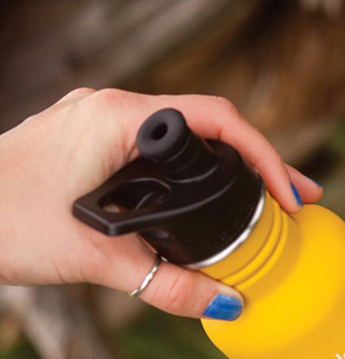 The hand closing the yellow Klean Kanteen with the Water Bottle Sport Cap. 