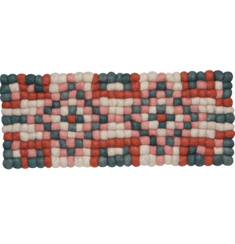 A dotted red, pink, blue, and white table runner made out of felted spheres.