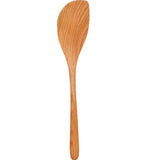A wooden stirring spoon stands up straight.