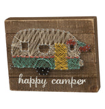 Stitchings that form a camper on a wooden brown background.