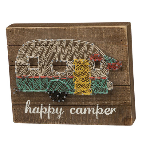 Stitchings that form a camper on a wooden brown background.