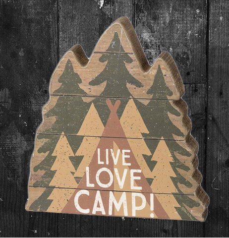The wooden cutout of three green pine trees back to back with a teepee in front of them and the words, "Live, Love, Camp" in front of the teepee now sits on a dark grey wooden background.
