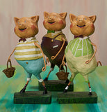 The Three Little Pig figurines standing together on the pink and green background