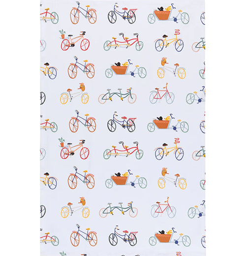 A white cotton tea towel with several bicycles printed on it. The bikes are all different colors; blue, orange, red, and gray.