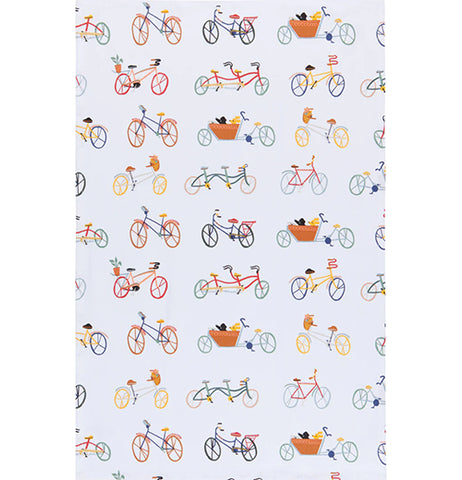 A white cotton tea towel with several bicycles printed on it. The bikes are all different colors; blue, orange, red, and gray.