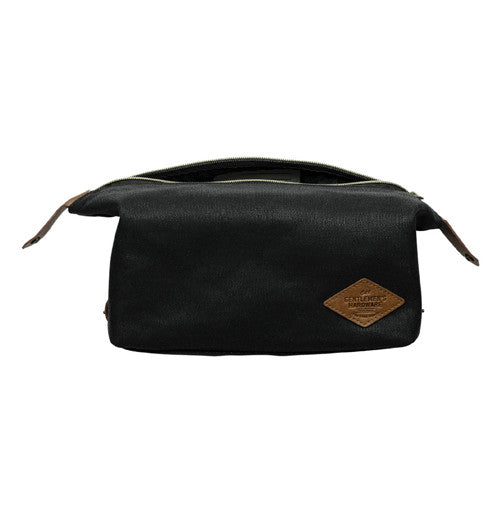 Black bag with brown leather tag that says "Gentleman&